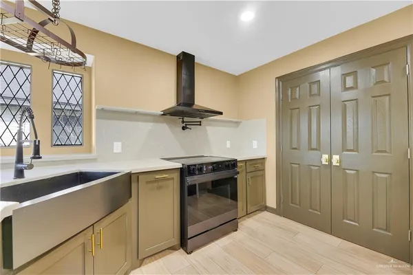a kitchen with stainless steel appliances granite countertop a sink and a stove