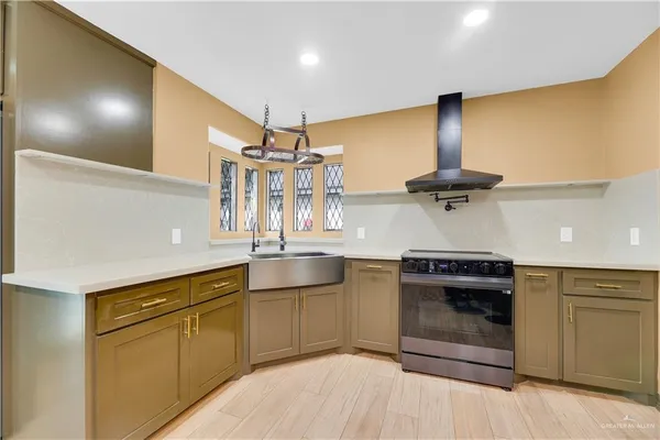 a kitchen with stainless steel appliances granite countertop a sink and cabinets