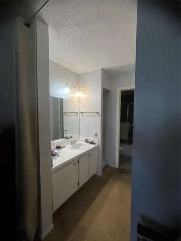 a bathroom with a double vanity sink and mirror