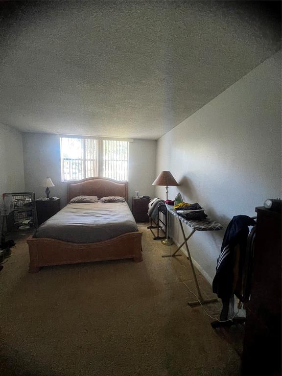 9091 Lime Bay Boulevard, Unit 114 Tamarac, FL 33321 - Photo 15 of 21 a bedroom with bed and window