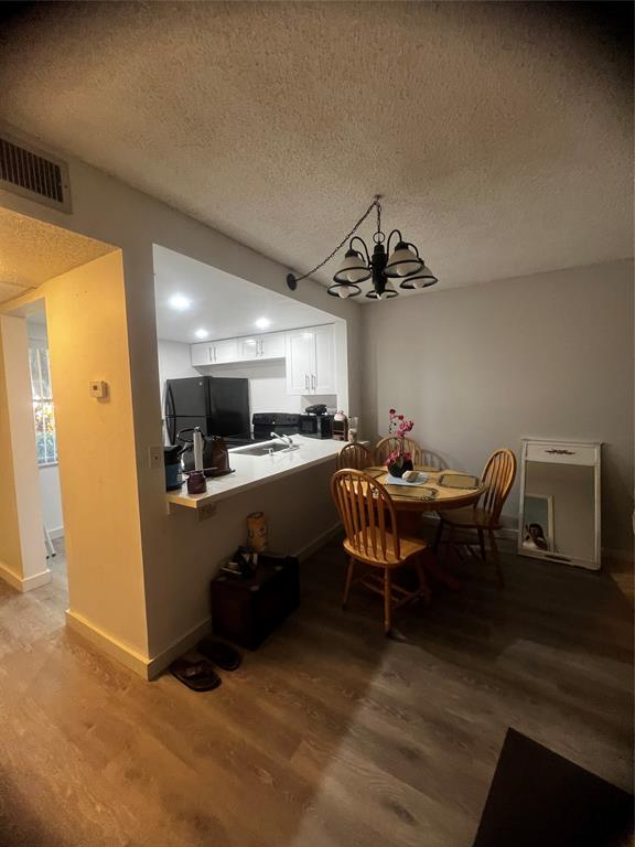 9091 Lime Bay Boulevard, Unit 114 Tamarac, FL 33321 - Photo 16 of 21 a living room with furniture and a chandelier