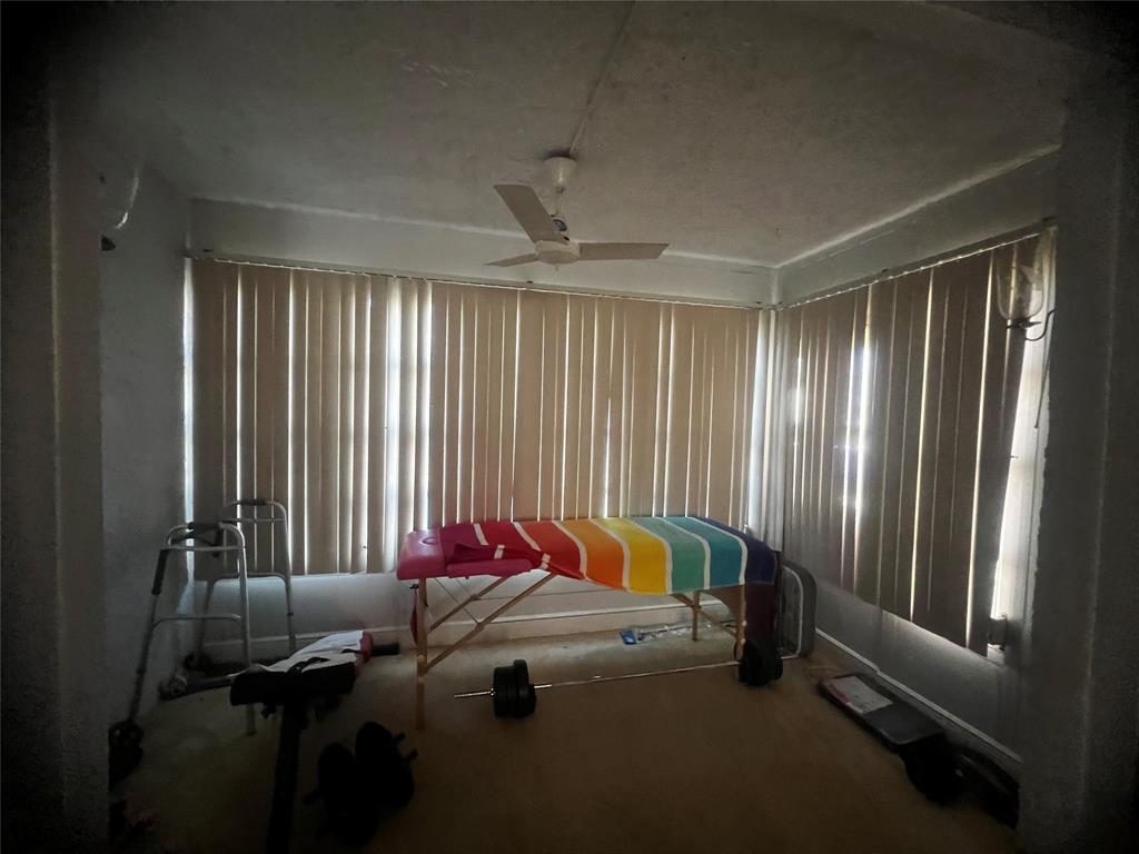 9091 Lime Bay Boulevard, Unit 114 Tamarac, FL 33321 - Photo 17 of 21 a bed room with a bed and a window