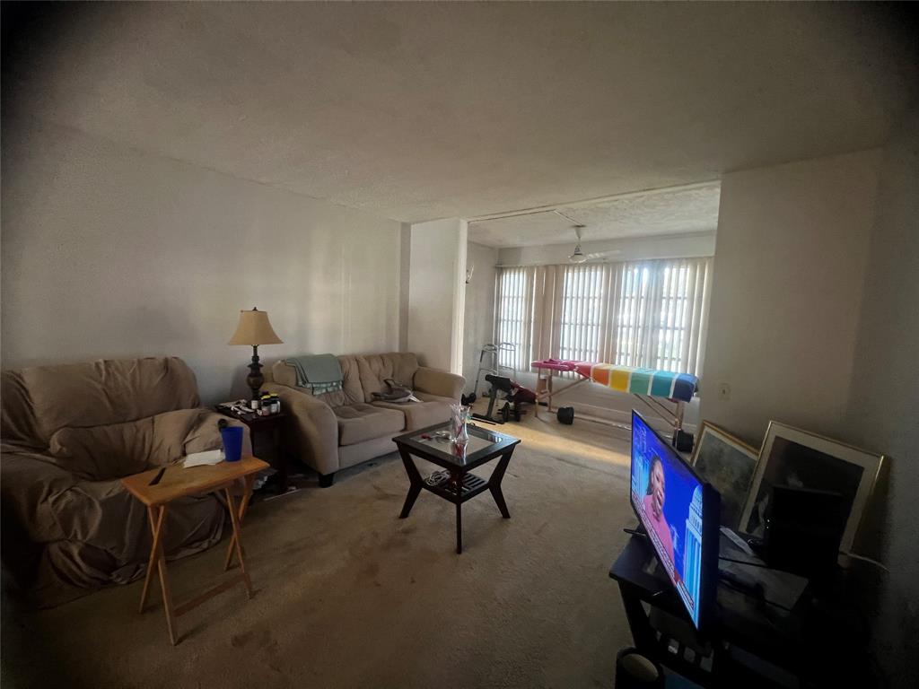 9091 Lime Bay Boulevard, Unit 114 Tamarac, FL 33321 - Photo 19 of 21 a living room with furniture and a window