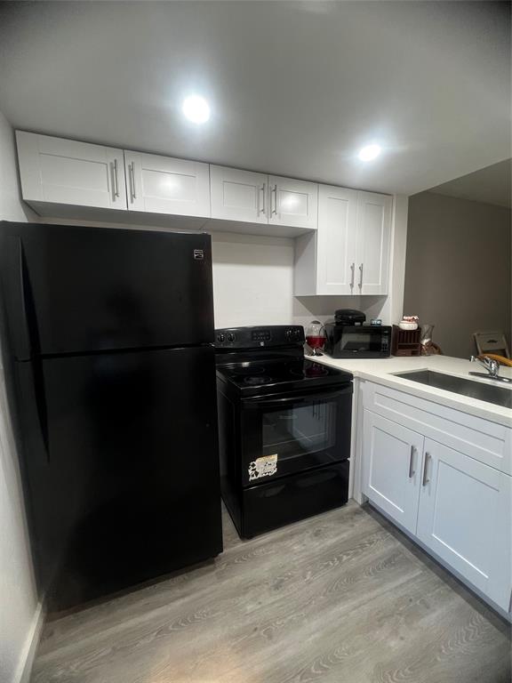 9091 Lime Bay Boulevard, Unit 114 Tamarac, FL 33321 - Photo 5 of 21 a kitchen with a sink and a stove