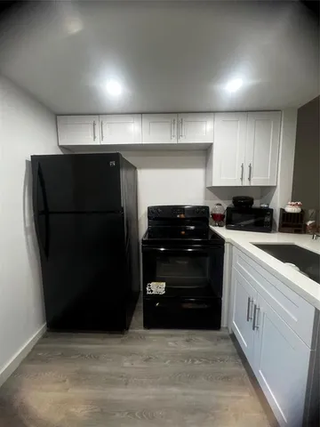 a kitchen with a refrigerator and a stove