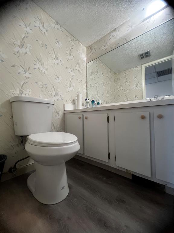 9091 Lime Bay Boulevard, Unit 114 Tamarac, FL 33321 - Photo 7 of 21 a bathroom with a toilet sink and mirror