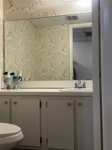 a bathroom with a sink and mirror