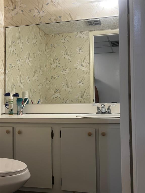 9091 Lime Bay Boulevard, Unit 114 Tamarac, FL 33321 - Photo 8 of 21 a bathroom with a sink and mirror