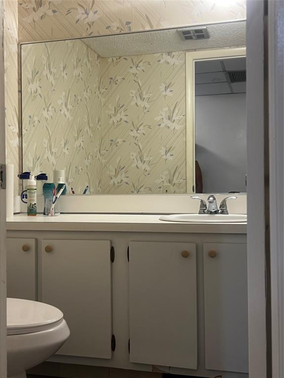 9091 Lime Bay Boulevard, Unit 114 Tamarac, FL 33321 - Photo 9 of 21 a bathroom with a sink and a toilet