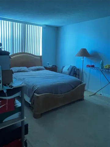 a bedroom with a bed and a night stand