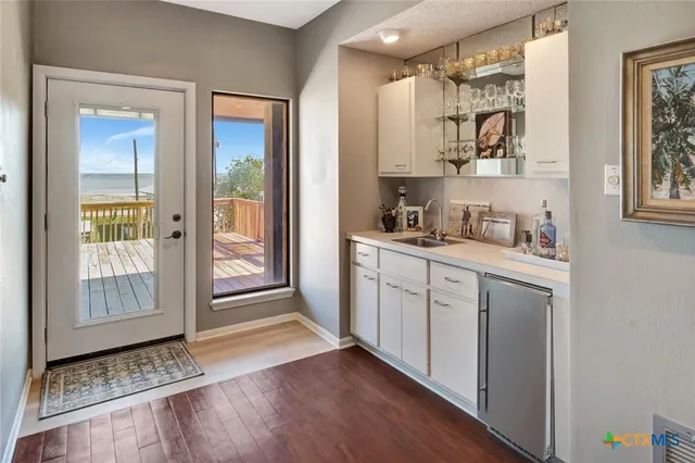 a kitchen with cabinets and wooden floor