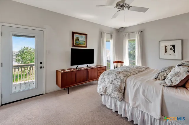 a spacious bedroom with a bed and a flat screen tv