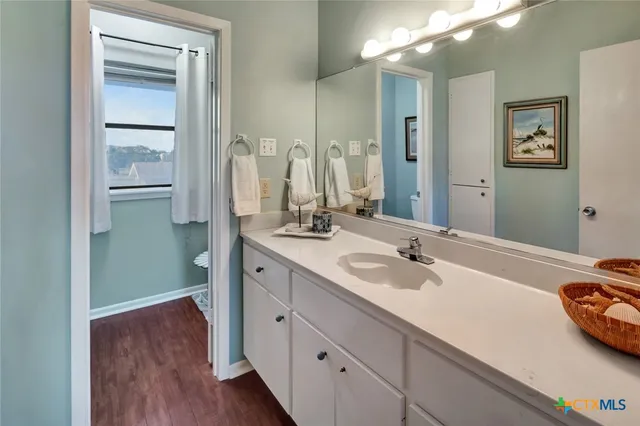 a spacious bathroom with a double vanity sink and mirror