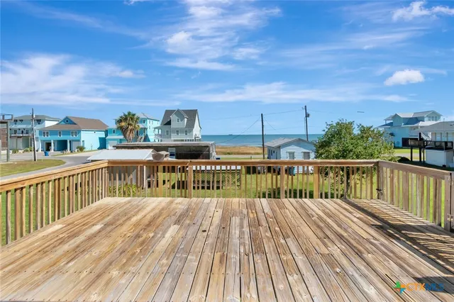 a view of balcony with wooden floor and fence