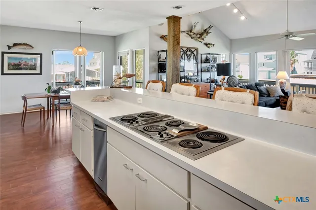 a kitchen with stove and a dining table