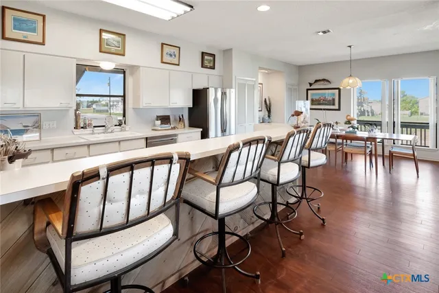 a view of kitchen with cabinets and wooden floor