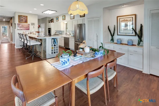 a view of a dining room with furniture and wooden floor