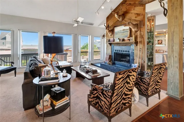 a living room with furniture a fireplace and a flat screen tv