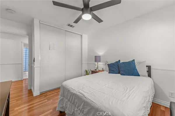 a bedroom with a large bed and a chandelier