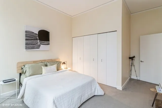 a bedroom with a bed and a wall painting