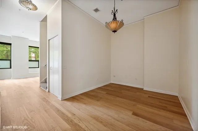 a view of empty room with wooden floor
