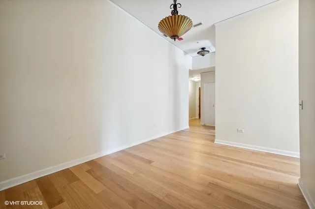 a view of an empty room with a chandelier