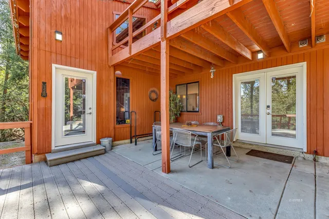 a living room with furniture a fireplace and a floor to ceiling window