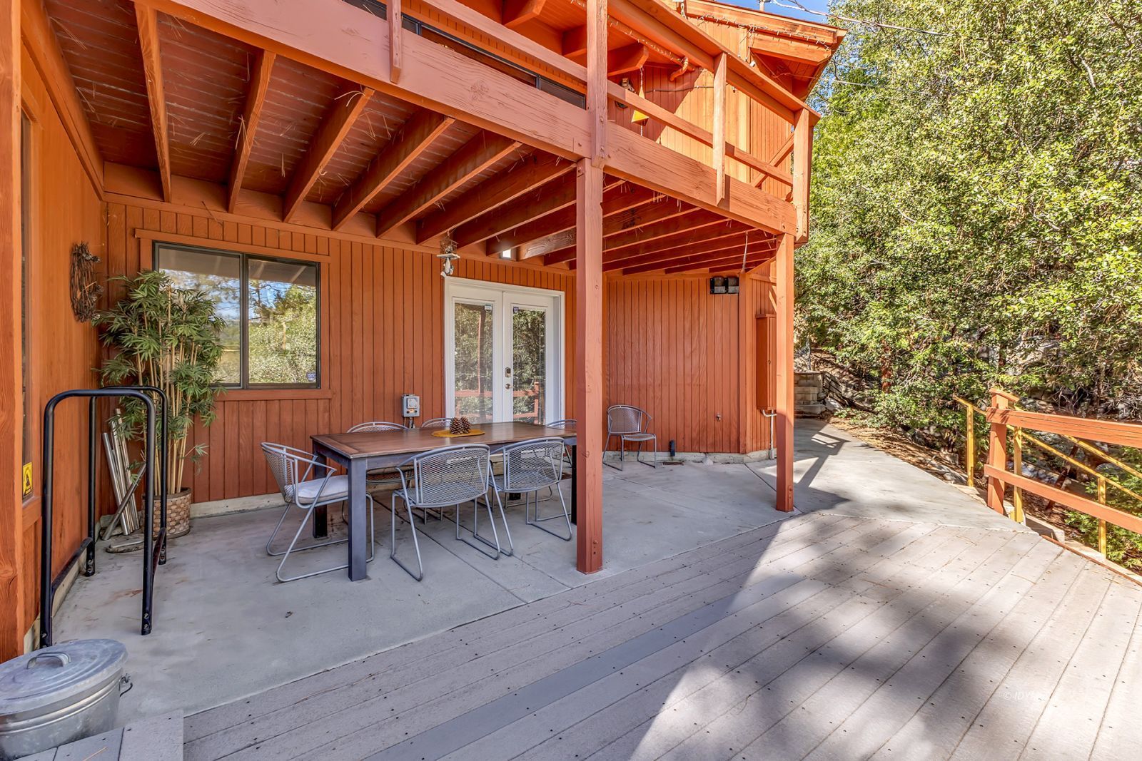 53580 Jeffery Pine Road Idyllwild, CA 92549 - Photo 13 of 90 a view of a patio with table and chairs with wooden floor and fence