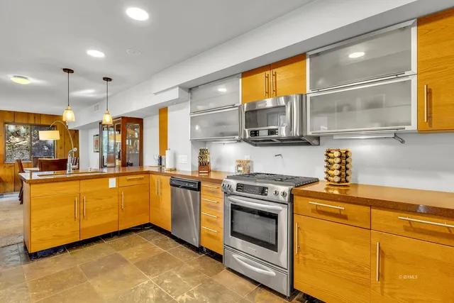a view of a kitchen from a hallway