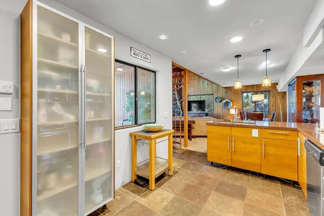 a kitchen with a sink a window and cabinets