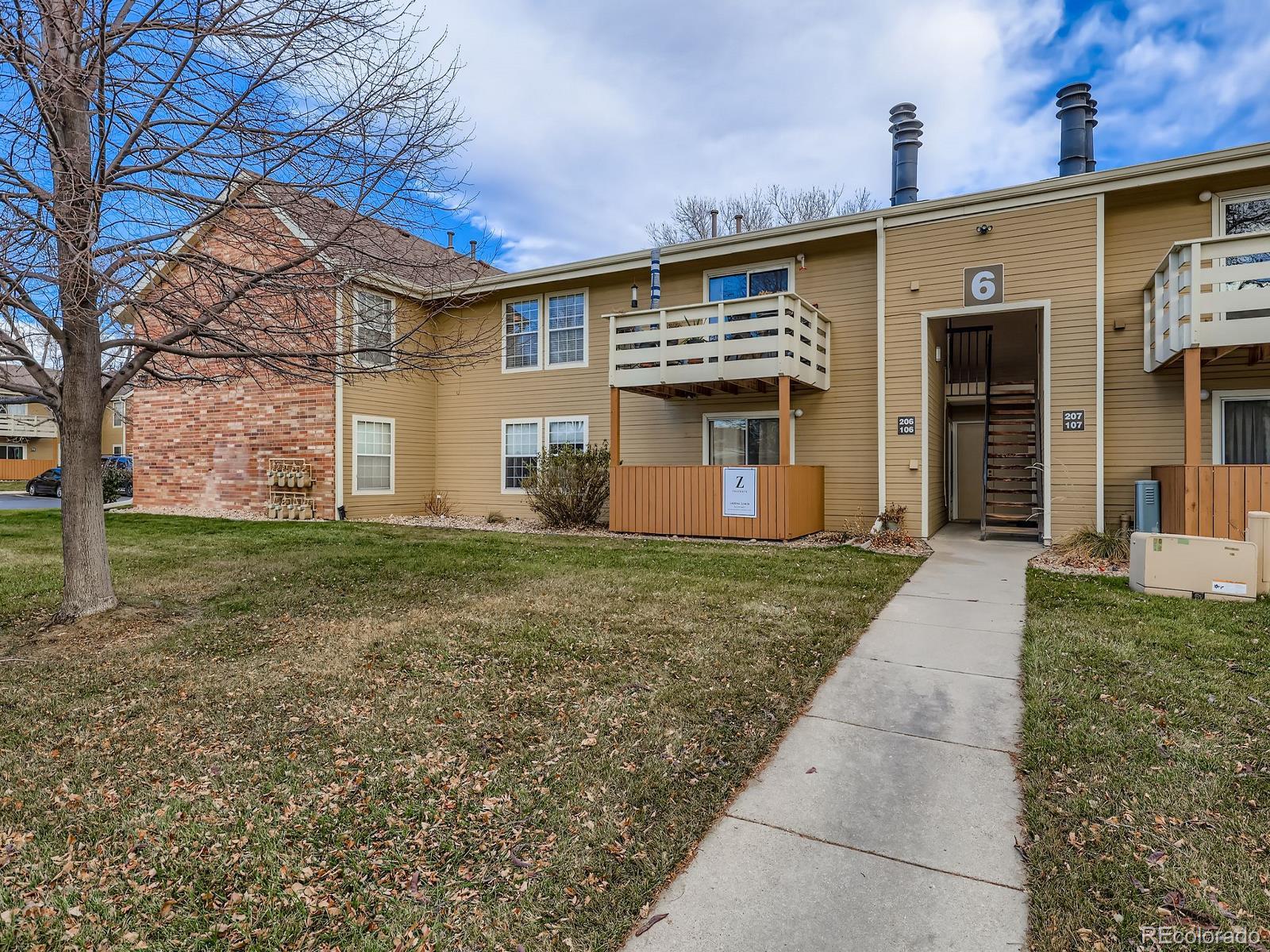 10251 West 44th Avenue, Unit 6106 Wheat Ridge, CO 80033 - Photo 1 of 17 a front view of house with yard