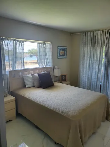 a bed sitting in a bedroom next to a window