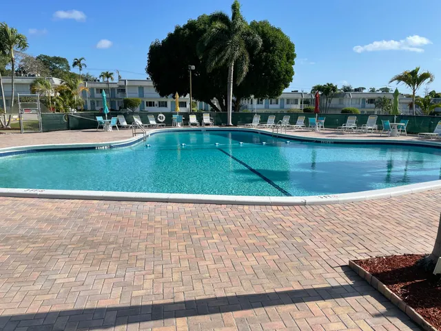 a view of swimming pool with outdoor seating and lake view