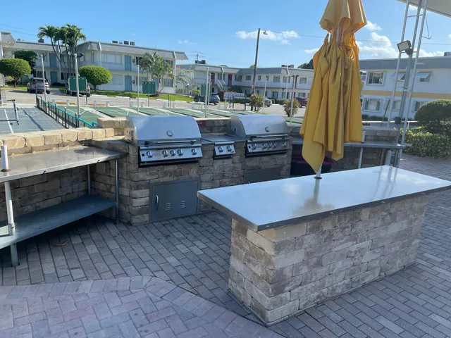 a view of a patio with dining table and chairs