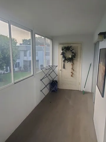 a view of an empty room and a window