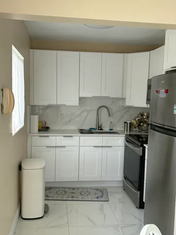 a kitchen with a sink appliances and cabinets