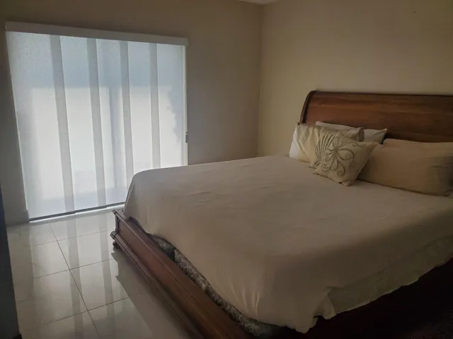 a bed sitting in a bedroom next to a cabinet