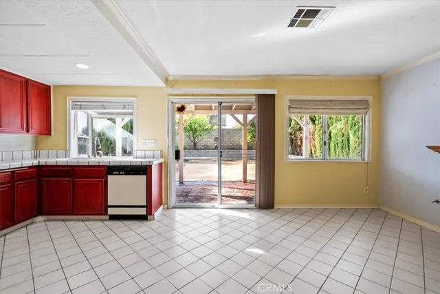 a kitchen with granite countertop a stove a sink and a microwave