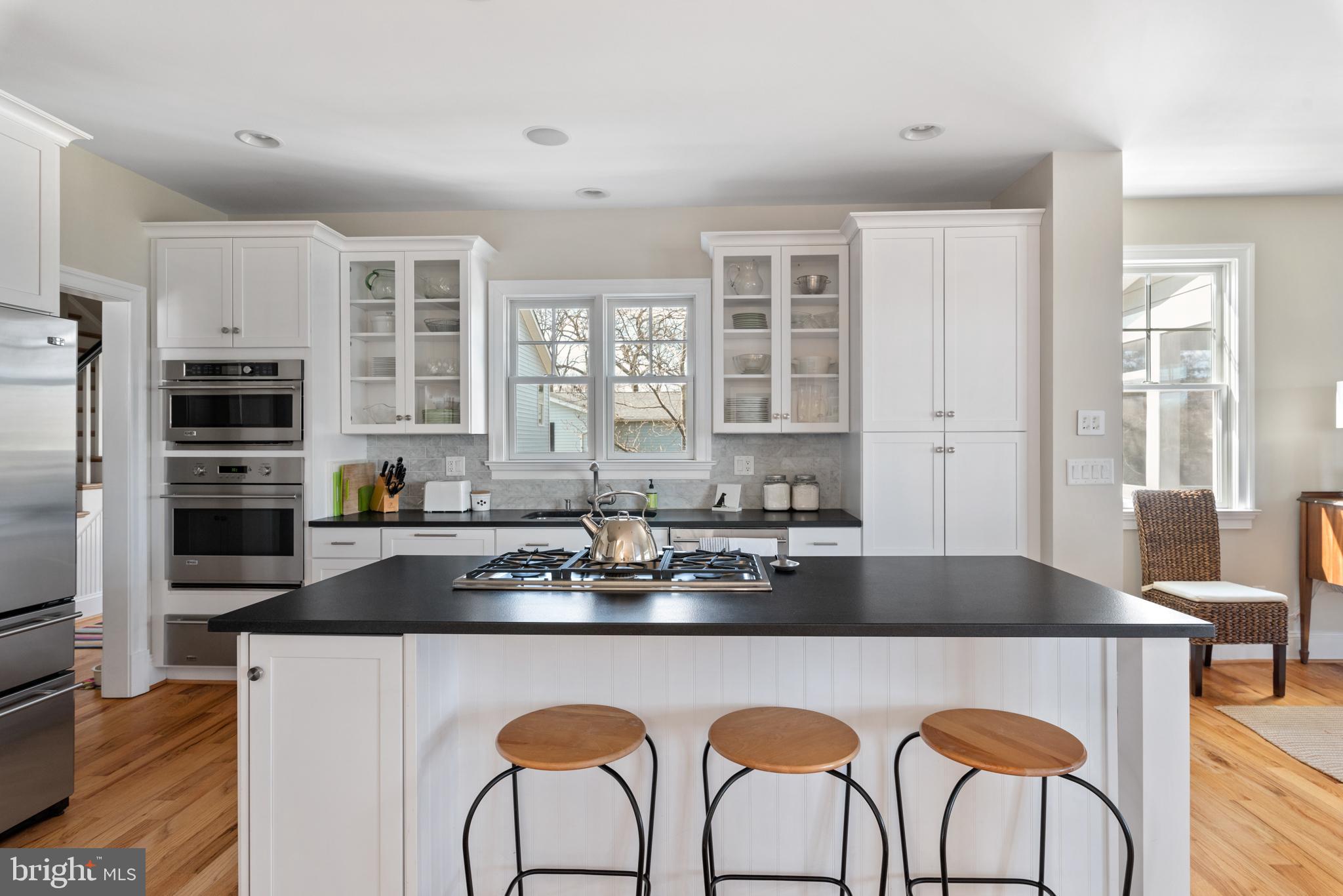 708 Black Forest Road Annapolis, MD 21409 - Photo 31 of 82 a kitchen with stainless steel appliances granite countertop a stove top oven a sink a dining table and chairs