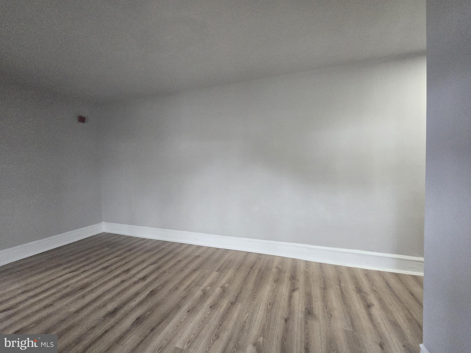 6700-6702 Keystone Street Philadelphia, PA 19135 - Photo 2 of 10 a view of an empty room with wooden floor