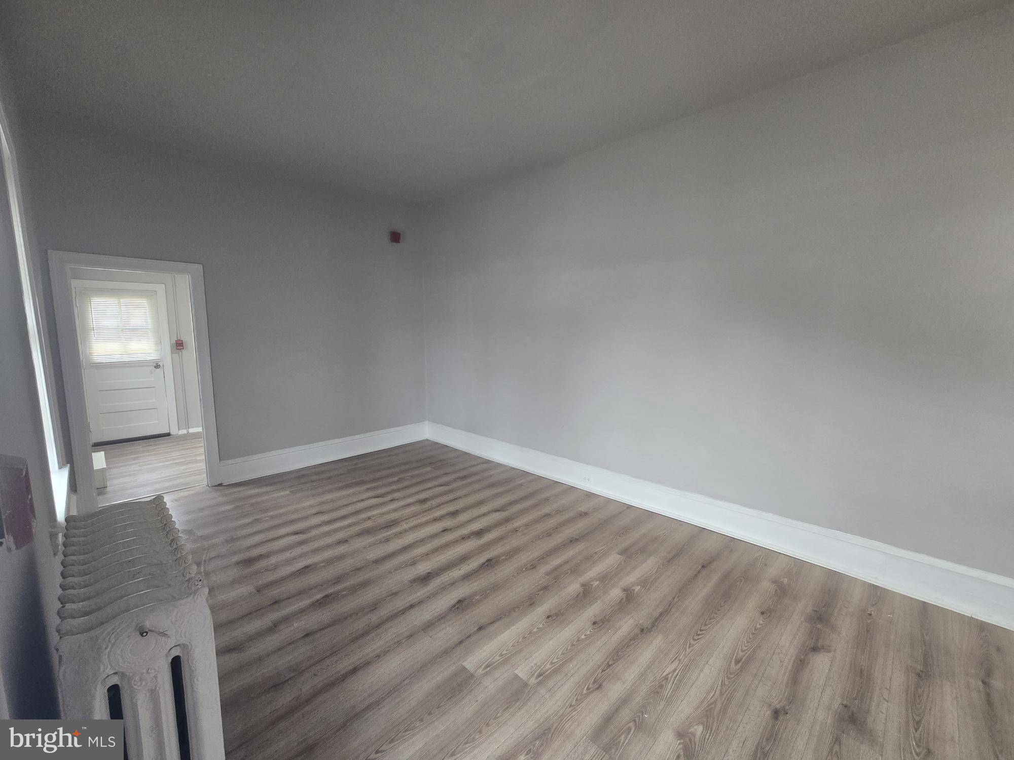 6700-6702 Keystone Street Philadelphia, PA 19135 - Photo 3 of 10 a view of an empty room and wooden floor