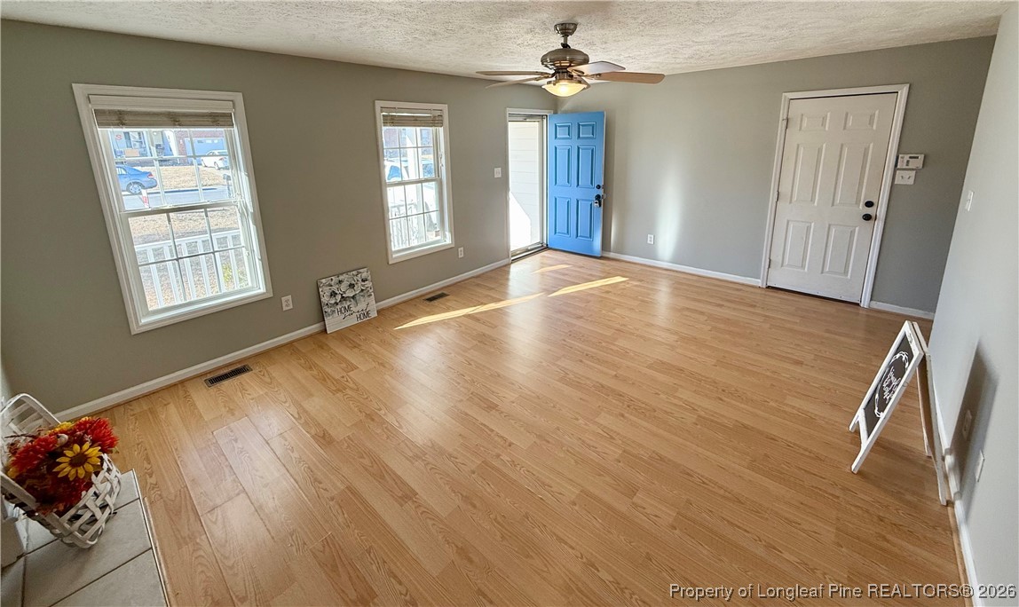 2905 Bakers Mill Road Fayetteville, NC 28306 - Photo 5 of 24 a view of empty room with wooden floor and fan