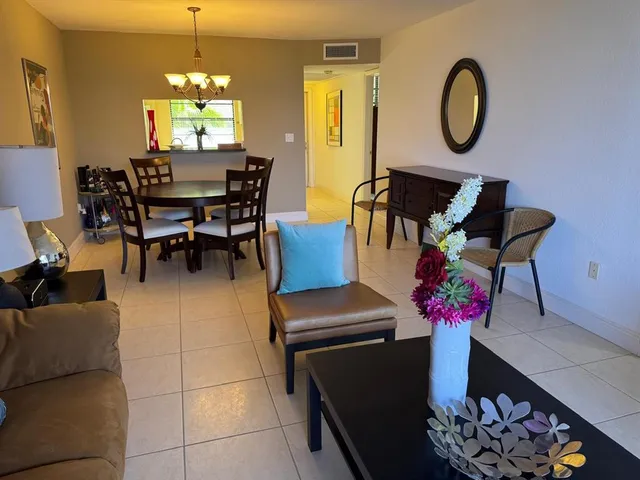 a view of a dining room with furniture and a chandelier