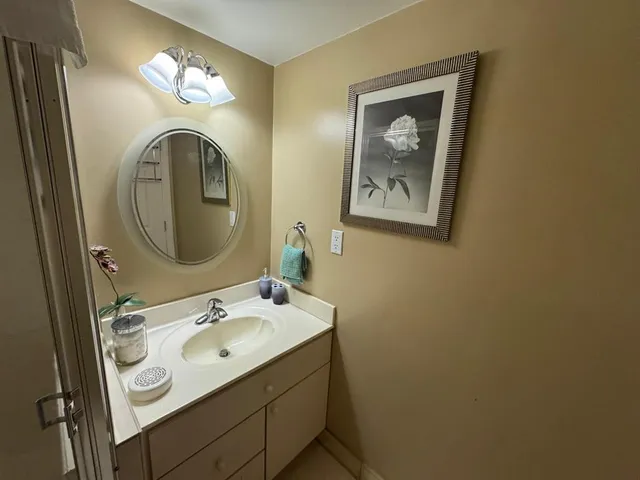 a bathroom with a sink and mirror