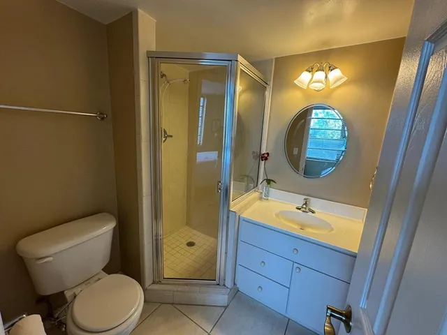 a view of a balcony with couches and red umbrella
