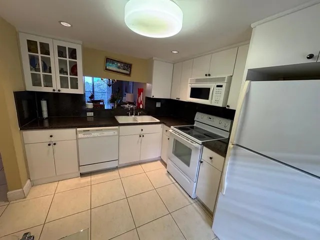 a kitchen with stainless steel appliances a stove a sink and a microwave