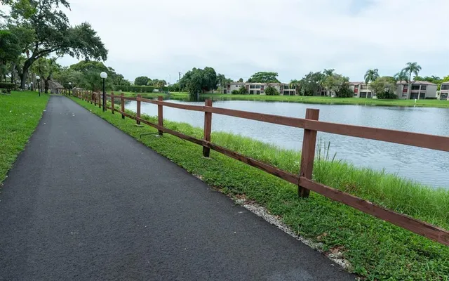 a view of a car parked in front of a house with a yard