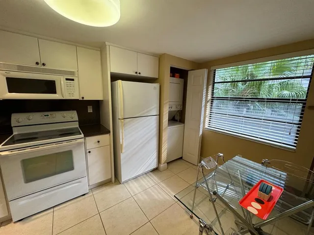 a kitchen with a stove a refrigerator and a cabinets
