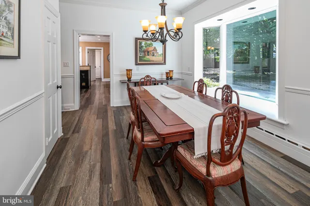 a kitchen with a stove and a wooden floor