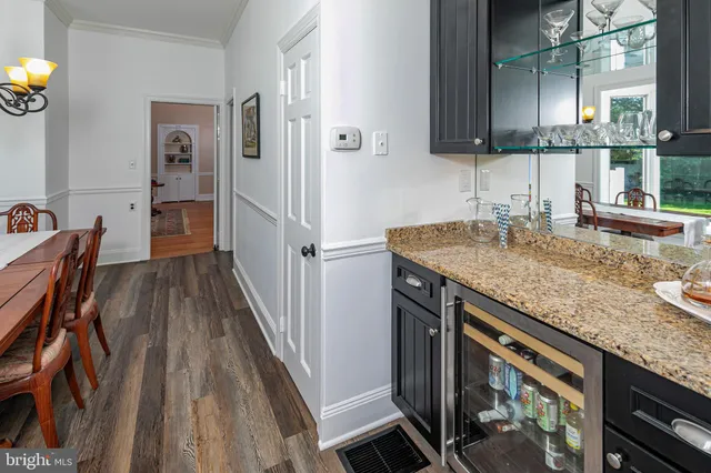 a kitchen with granite countertop a sink stove and cabinets